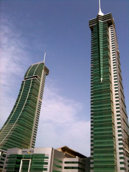 two buildings with one building in the foreground with a sky background
