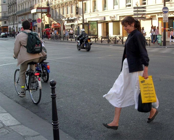 pedestrians and bicyclists are passing by a street corner