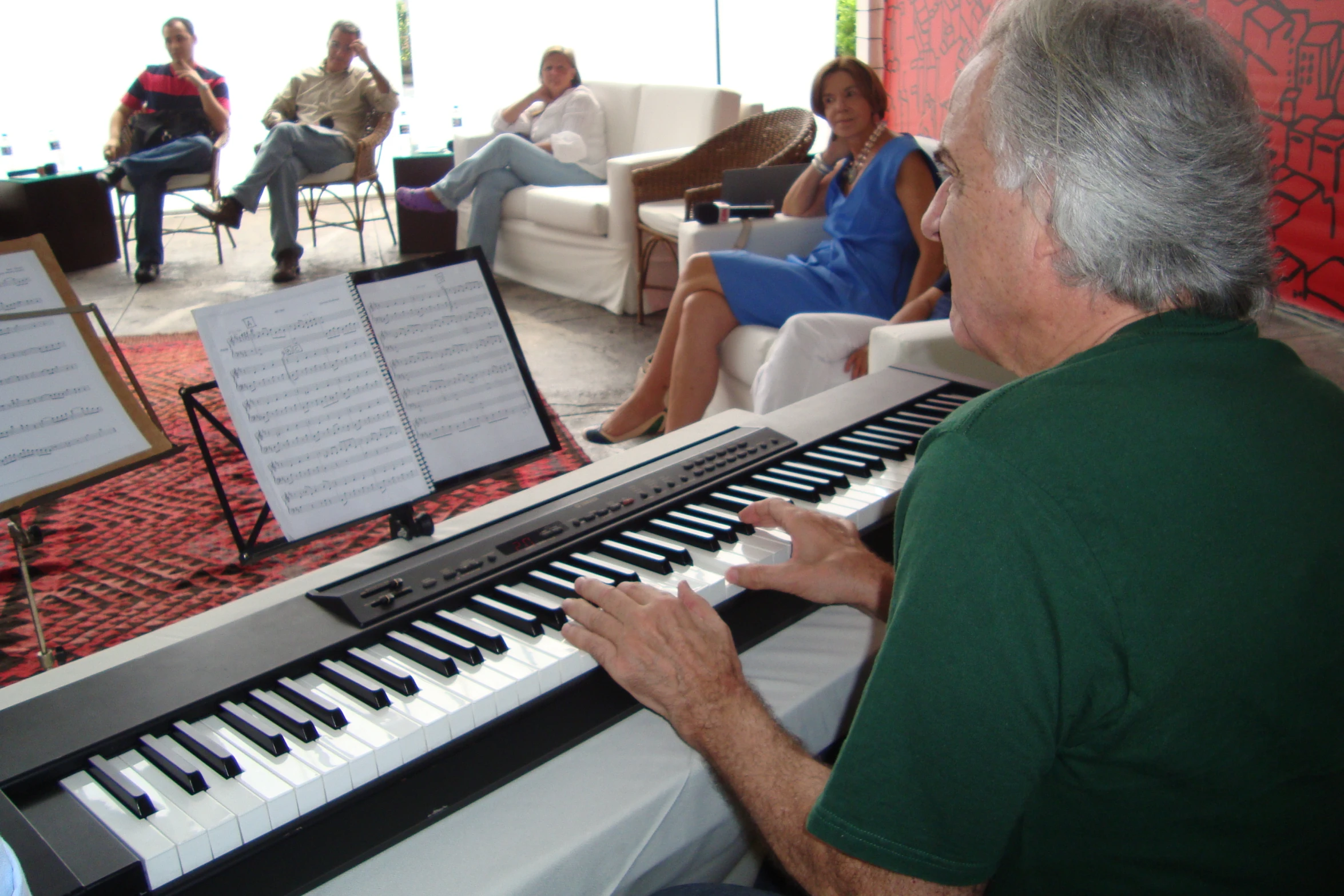 some people playing music on an electric keyboard