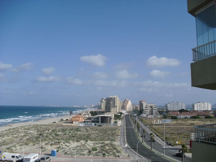 a beach side road is pictured near a city