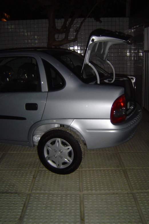 a silver car with the back of the open hatch up