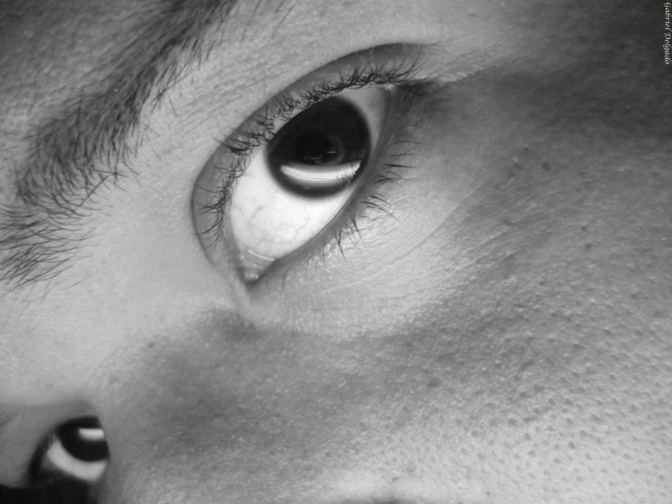 a close up s of someone's eye looking over their shoulder