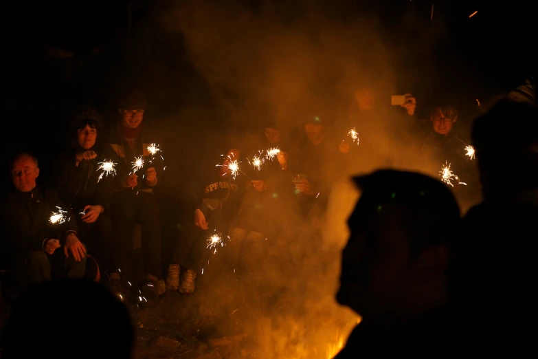 a group of people holding sparklers in their hands