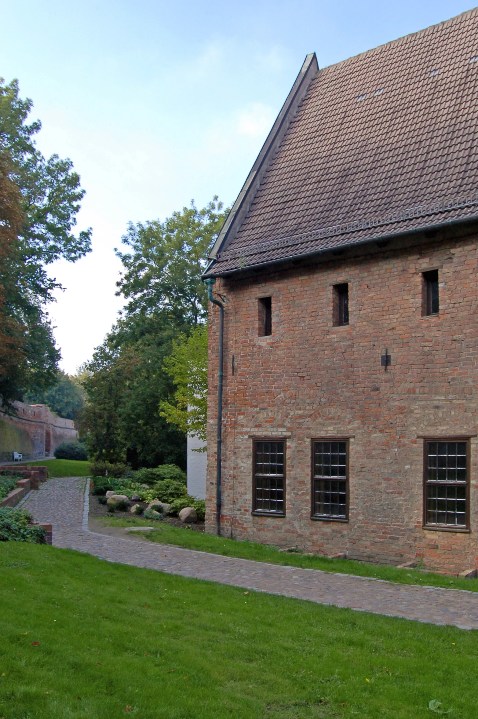 a building with windows and small gardens near it