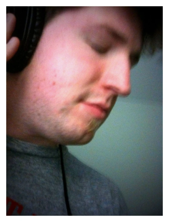 a man with headphones looking at his phone