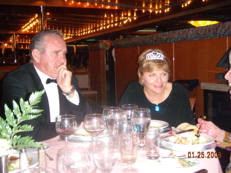 the men are sitting down at the table and eating