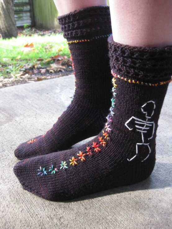 a close up view of someone wearing socks with colorful flowers on them