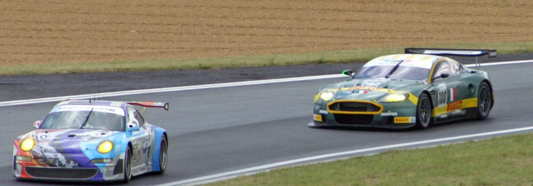 two cars in motion on a track next to each other