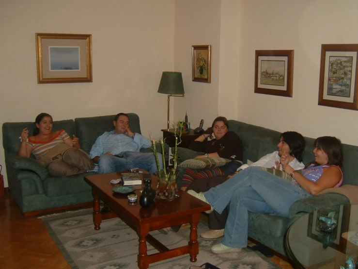 a group of people in a room sitting on a couch