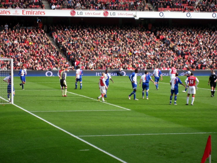 a group of people playing soccer on a green field