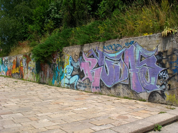 a city wall with grafitti on it