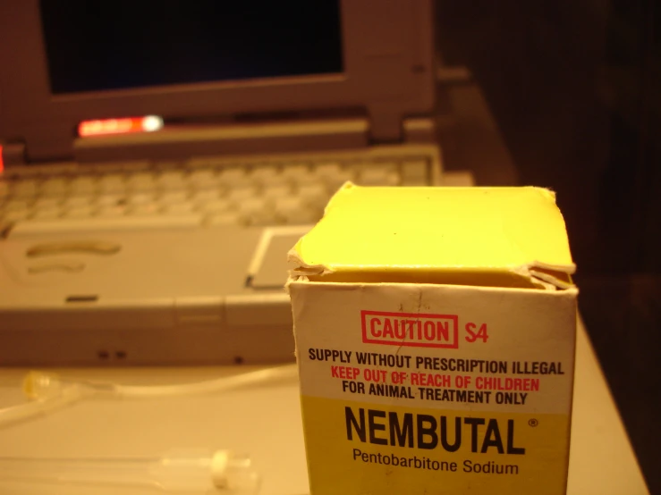 an open box sitting on top of a desk next to a laptop