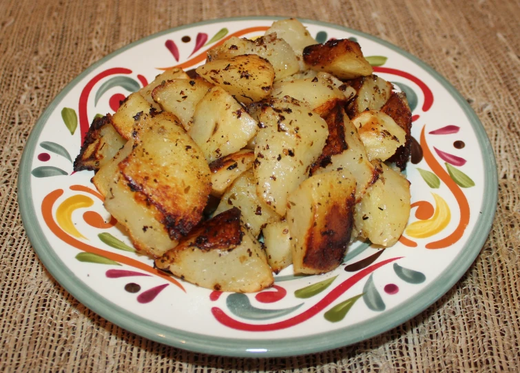 plate of potatoes with seasoning on it on burlap table