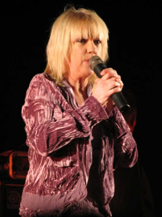 a person holding a microphone with their hand