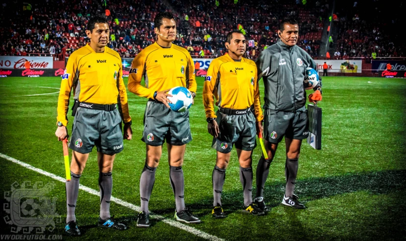 three soccer players standing together on the field