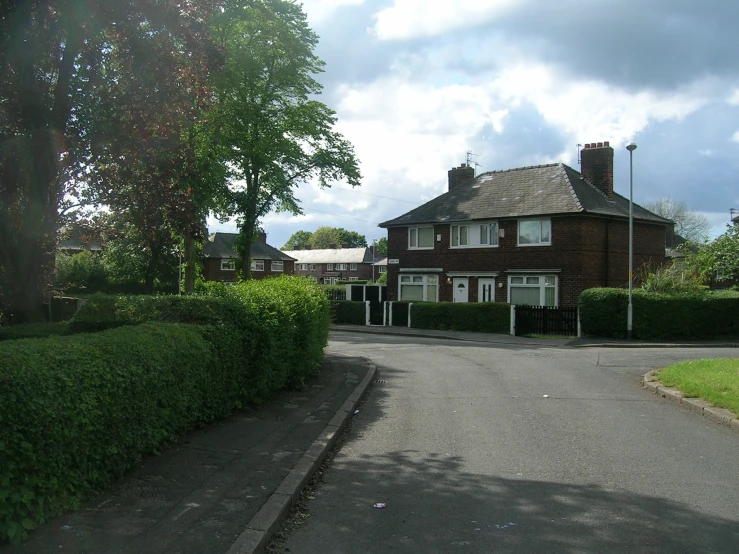 a house is standing alone with a large front garden