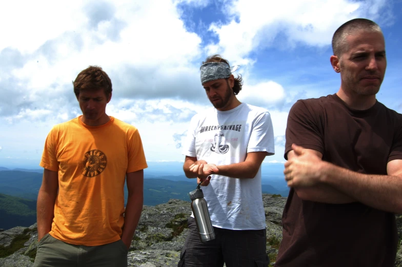 three young men are looking at the camera