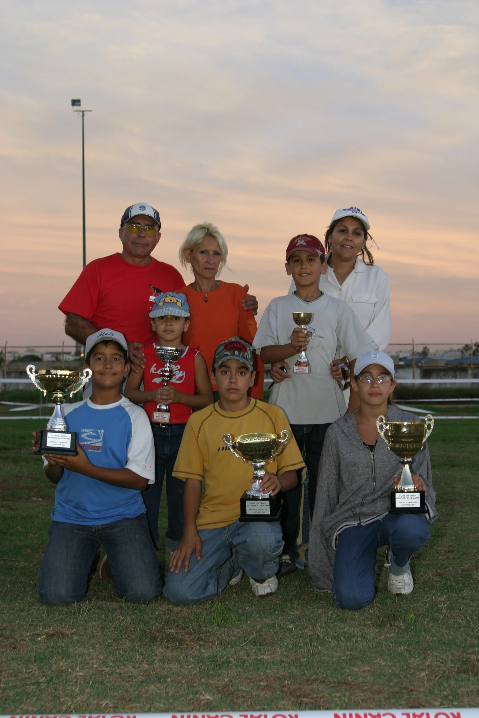 a group of young people posing with trophies