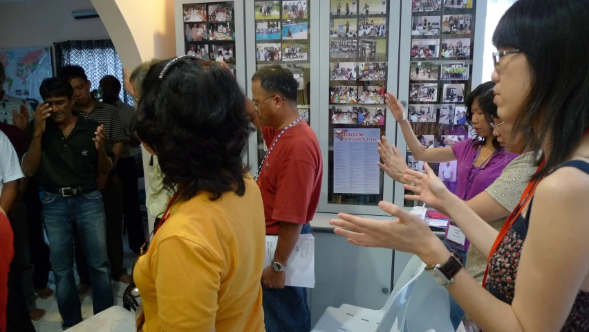 people looking at and checking a display of video game memorabilia