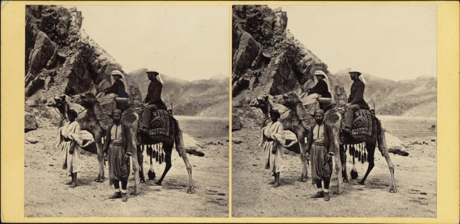 two people are riding horses next to rocks