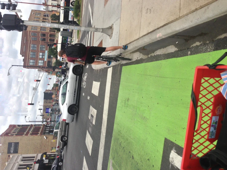 a man riding a bicycle across a crosswalk