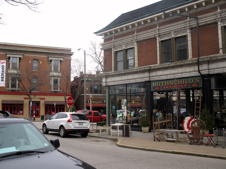 the corner of an intersection with several parked cars