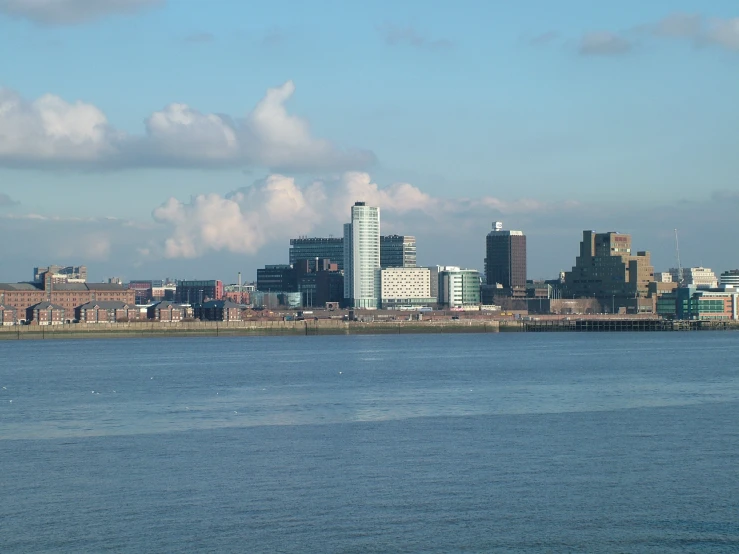 a body of water with city buildings near by