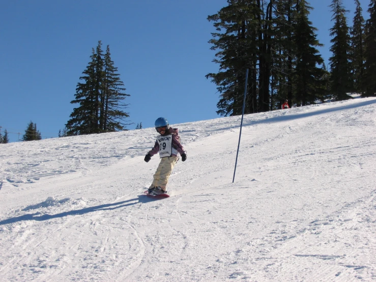 a man snow boarding down the mountain side