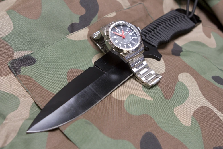 the military knife with a black blade is attached to the knife