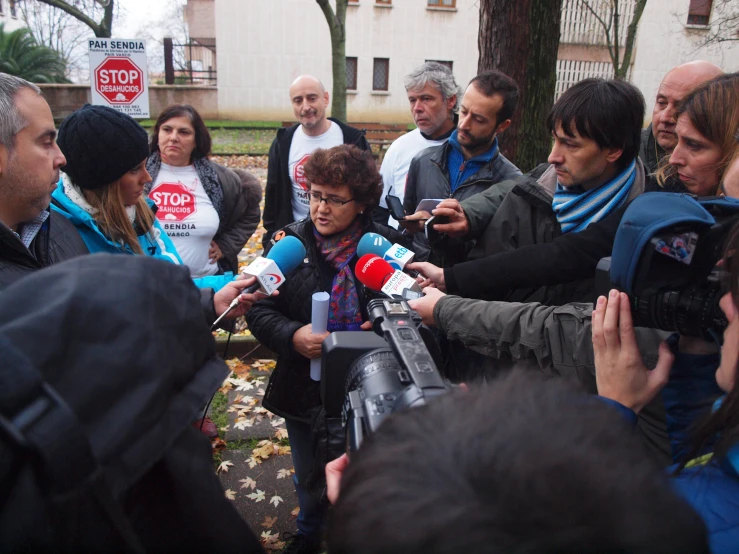 people gather outside at a political rally on the street