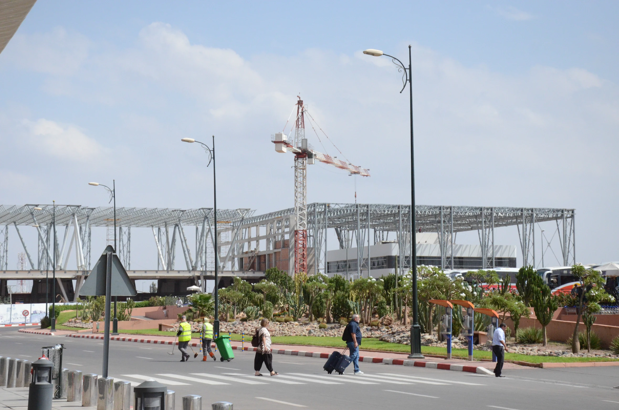 a large construction area with people walking across the street