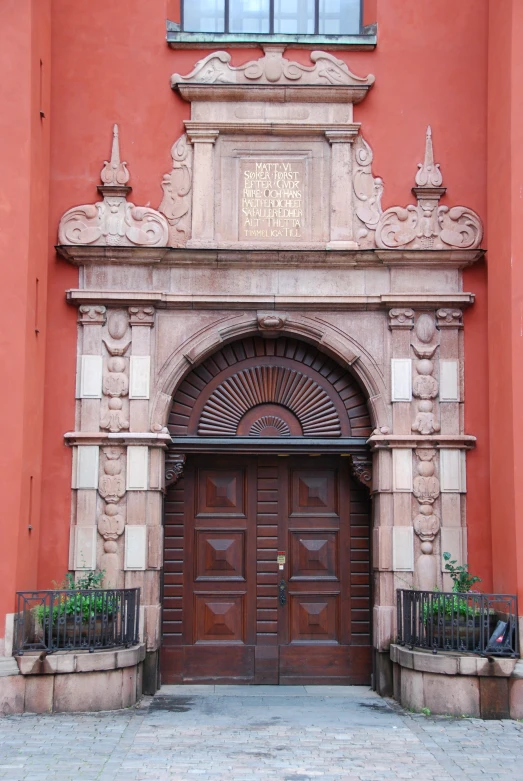 a tall wooden entrance to an old building