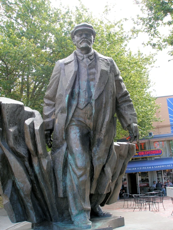 a statue of a man holding a stone object