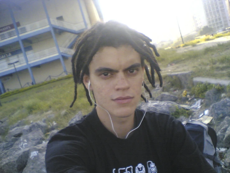 a person with dreads on taking a picture