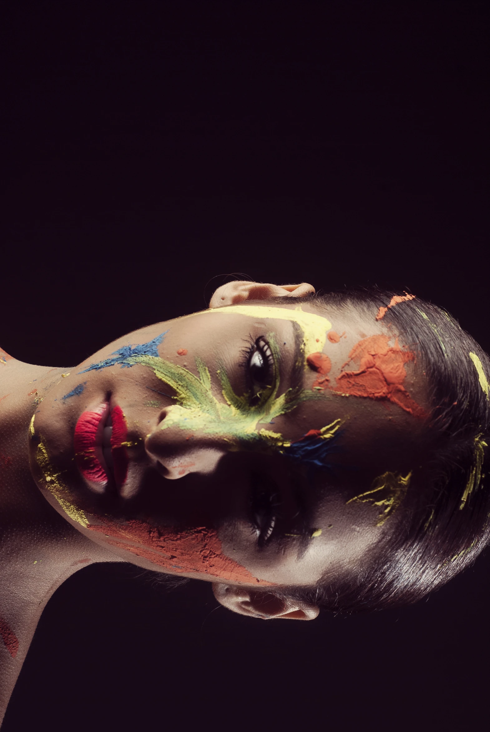 a woman's face painted and painted with different colors