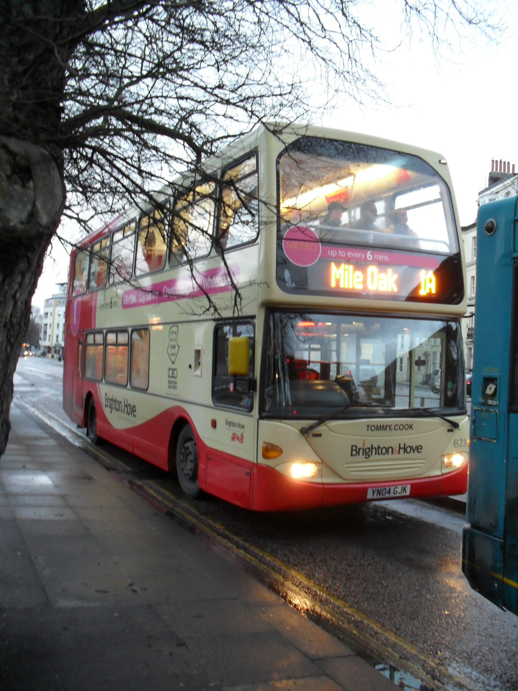 the bus is stopped on the side of the street