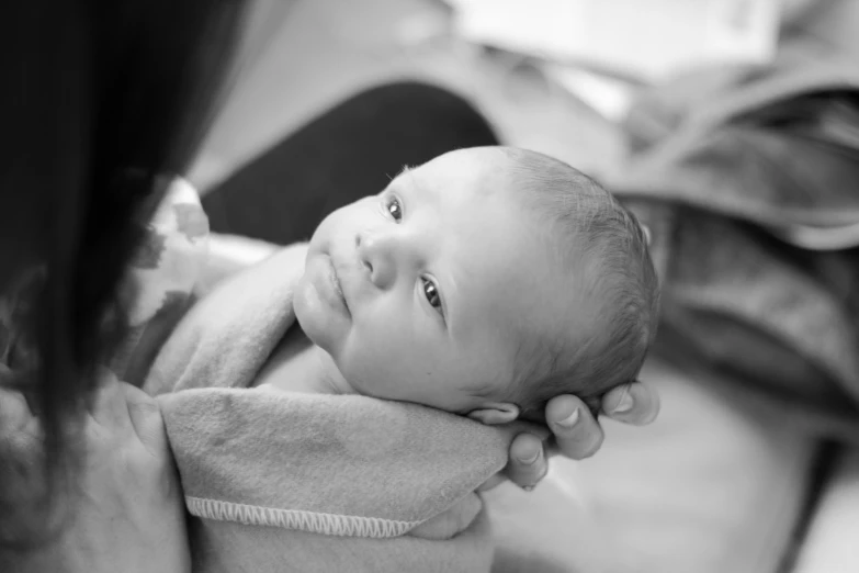 a woman is holding a baby up