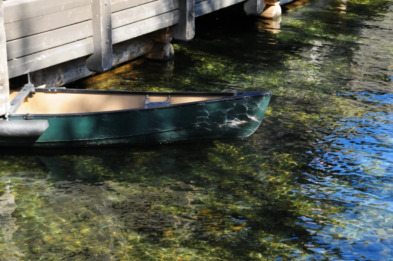 a rowboat is tied up at the edge of the water