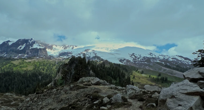 a bunch of rocks on top of a mountain with snow