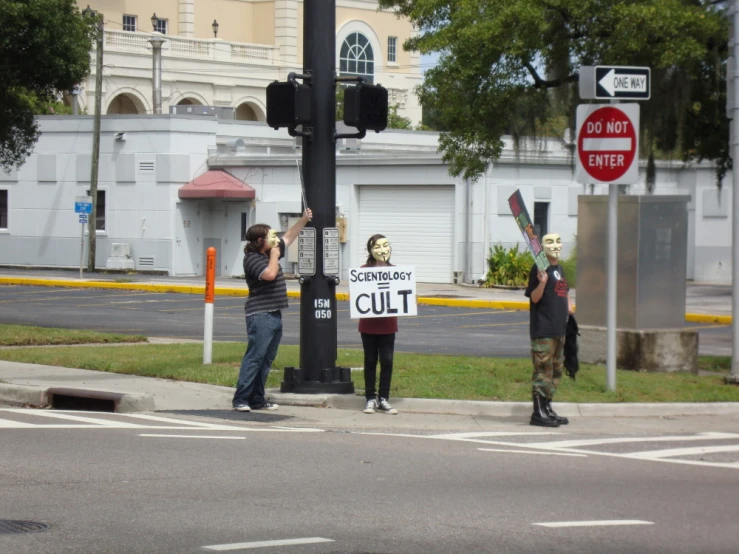 two men are holding protest signs in the street