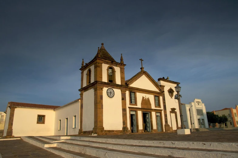 a white church building with a tower clock at the top