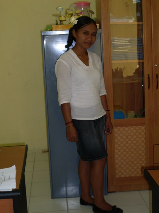 a woman standing in front of a refrigerator