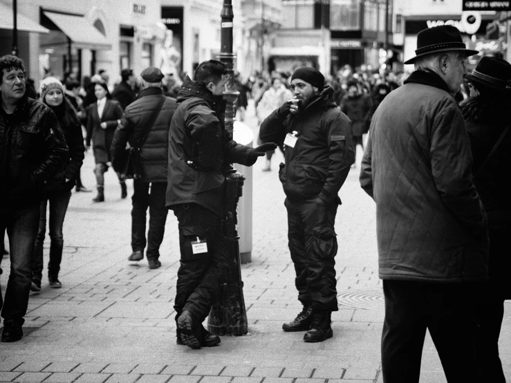 a group of people that are standing on the street