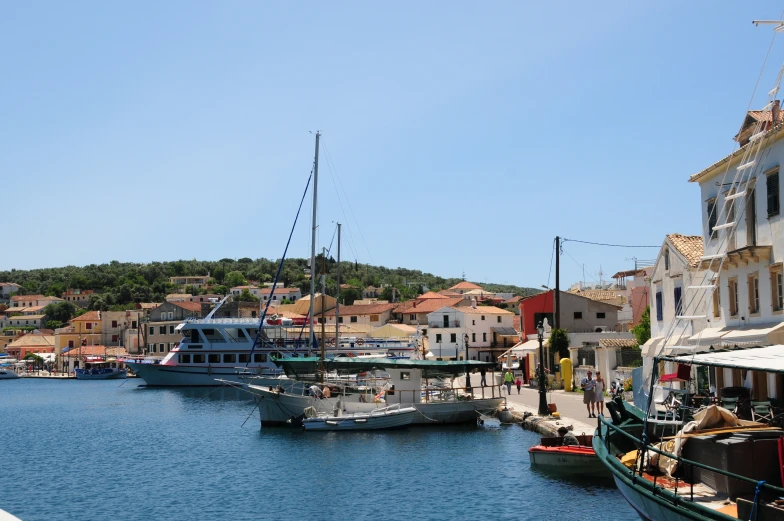 some boats sitting at a harbor near buildings