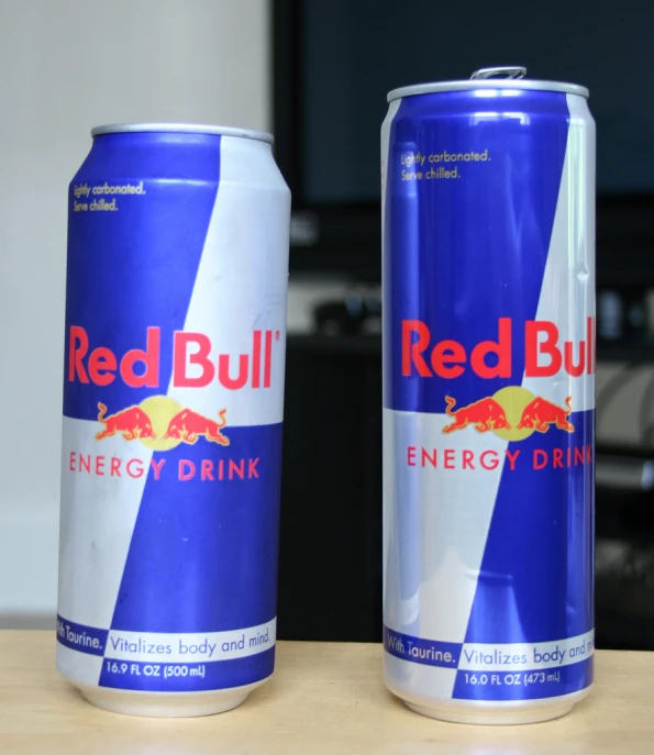 a red bull energy drink next to another energy drink