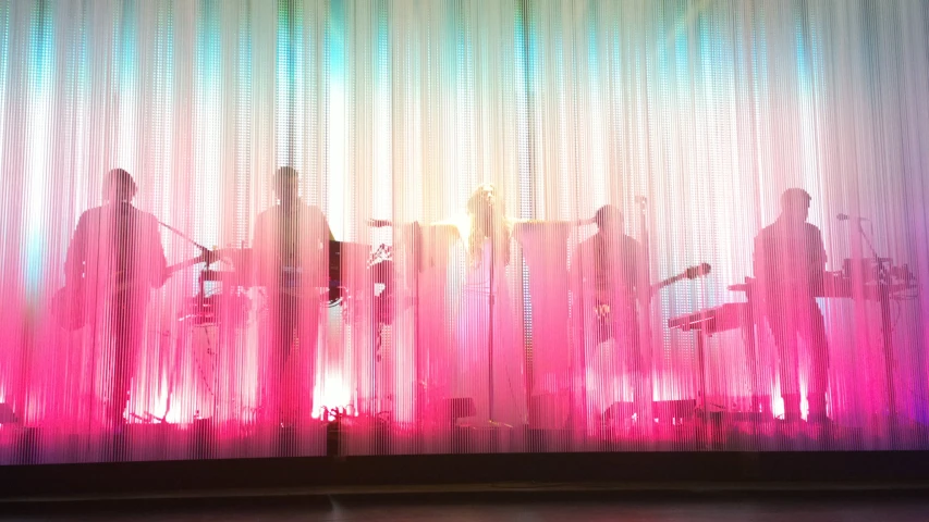 two musician on stage with purple curtain backdrop