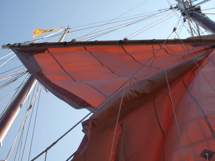 the mast and back of a sail boat during the day