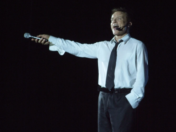 man with black tie and fake mustache talking on cellphone