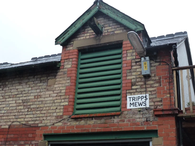 an old building with a window with a sign saying ripple mews on it