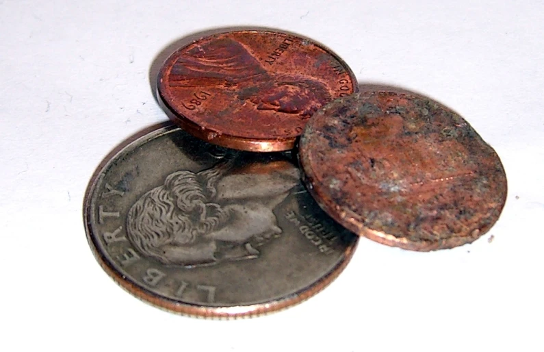 a brown penny is sitting on a white table